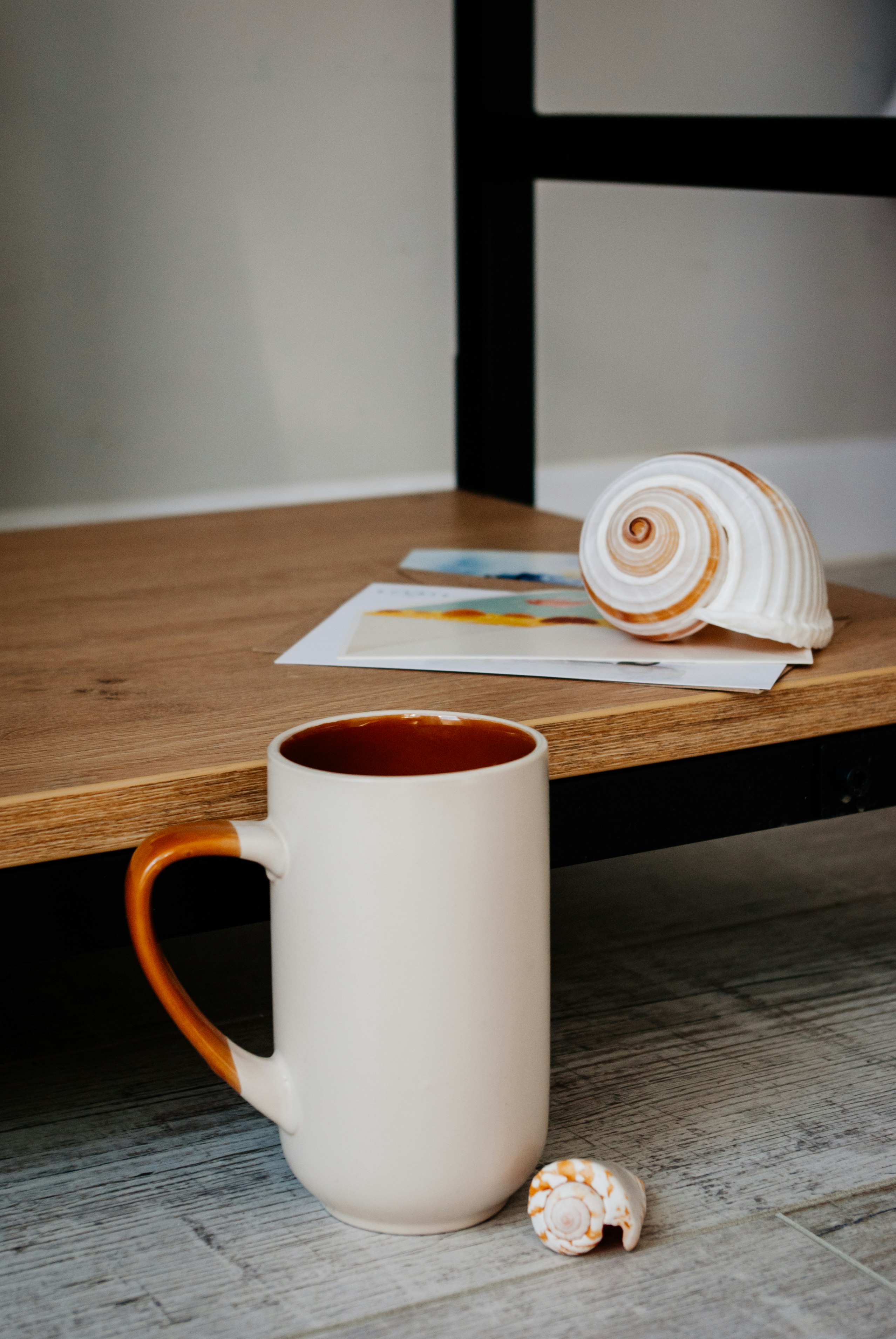 white ceramic mug on brown wooden table